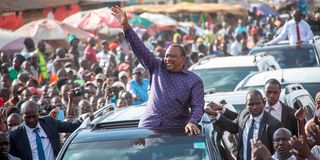 Former President Uhuru Kenyatta acknowledges greetings from Luanda and Kisumu City resident