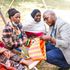 Eric Mutwiri, an economist, samples baskets made by women groups in Tharaka Nithi County.
