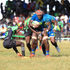 KCB's Davis Chenge charges past Daniel Angwech of Kabras Sugar