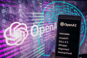 The OpenAI logo on screen with ChatGPT website