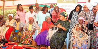 Tessie Musalia (centre) watches as Beatrice Wambui, 73, weaves a basket at Muthithi location, Kigumo constituency.