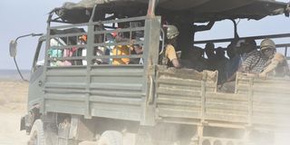 A police vehicle carries mourners to the burial of a bandit attack victim in Kapedo on the border of Turkana and Baringo 