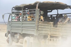 A police vehicle carries mourners to the burial of a bandit attack victim in Kapedo on the border of Turkana and Baringo 