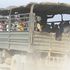 A police vehicle carries mourners to the burial of a bandit attack victim in Kapedo on the border of Turkana and Baringo 