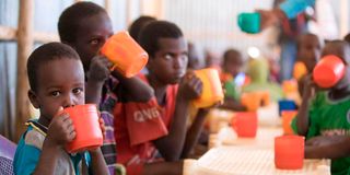 children drinking from cups 