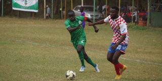 Gor Mahia defender Geoffrey Ochieng (left) vies with Nzoia Sugar midfielder Felicien Okanda