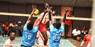 David Neeke (left) and Eugene Okello of Trailblazers block an attack from Timon Kimutai of Kenya Prisons