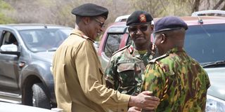 Rift Valley Regional Commissioner Abdi Hassan (left), talks to security officers after a regional security meeting