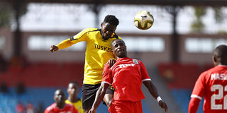 Tusker's Daniel Sakari (left) vies for an aerial ball with Lumumba Issa of Ulinzi Stars