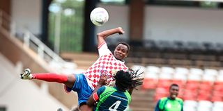 Nzoia Sugar midfielder Hassan Beja (left) vies for the ball with KCB midfielder Michael Mutinda 