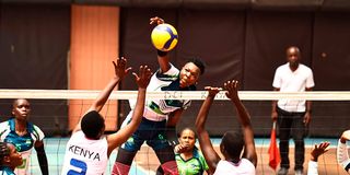 Mercy Chepkemboi (left) and Terry Wekesa of Kenya Defence Forces block an attack from Belinda Barasa (centre) of KCB 