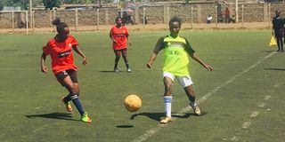 Kayole Ladies midfielder Dima Halima (left) vies for the ball with Falling Waters Barcelona striker Naomi Masinde