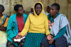 Ms Everline Miruka (centre) is consoled by relatives at the Coptic Hospital mortuary in Maseno, Kisumu County