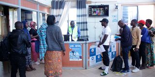 Passengers arriving in Kenya from Uganda at the Busia Border