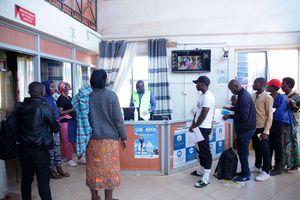 Passengers arriving in Kenya from Uganda at the Busia Border