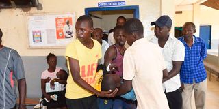 Members of the public carry an injured by into Marigat Sub-County Hospital in Baringo County on March 17, 2023