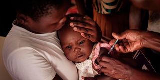 A child receives a shot during the launch of the extension of the world’s first malaria vaccine 