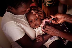 A child receives a shot during the launch of the extension of the world’s first malaria vaccine 