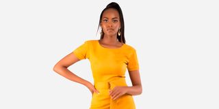 Michelle Harriet in a mustard yellow suede dress.