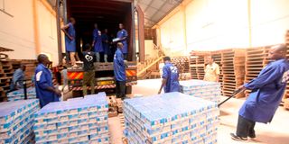 Workers load cartons of counterfeit Lato milk