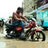 A boda boda rider maneuvers through a flooded section along First Avenue Eastleigh, Nairobi