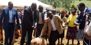Salva Kiir’s son Thiik Kiir Mayardit second (left), receiving an ewe from residents of Sawmill Village in Ainabkoi,