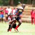 Eliude Kiyayi of Ofafa Jericho Secondary School is tackled by Gregory Mogire of Lenana School