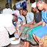 Archbishop Martin Kivuva washes the feet of Catholic faithful