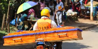 Boda boda rider transports a coffin