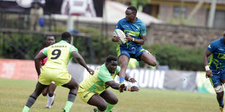 Isaac Njoroge (right) of KCB charges past Kabras Sugar's Emmanuel Otieno (centre) and Dan Angwech 