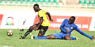 Tusker midfielder Shaphan Siwa (left) vies with Kenya Police defender Harun Shakava