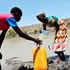 Women fetch water at an almost dried-up water pan at Bora Imani in Magarini, Kilifi County