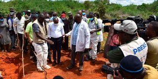 Interior Cabinet Secretary Kithure Kindiki is shown some of the mass graves by DCI Homicide Director Martin Nyuguto