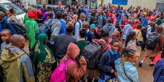 Travellers among them students wait to board Matatus at Afya Centre, Nairobi County