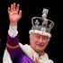 Britain's King Charles III wearing the Imperial State Crown, waves from the Buckingham Palace balcony