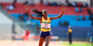 Winny Boinnett crosses the finish line to win the women's 3,000 metres steeplechase race