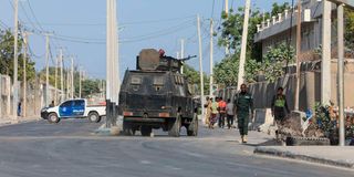 Security forces patrol outside a building which was attacked by suspected Al-Shabaab militants in Mogadishu 