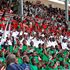 School children wave Kenyan flags during the 60th Madaraka Day celebrations at Moi Stadium in Embu