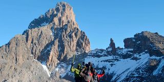 Trekkers at the top of Mt Kenya shortly after summiting the third highest peak, Point Lenana.