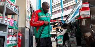 A pump attendant at the Rubis Energy Petroleum Station on Koinange Street in Nairobi County