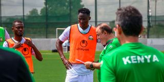 Harambee Stars coach Engin Firat (right) issues instructions as Abdallah Hassan (left) and Captain Michael Olunga