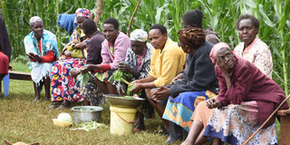 Mourners at the home of John Kirwa, whose wife was allegedly beheaded by her side lover on Monday night