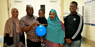 Mr Kase Bonaya holding his three-year-old son Mahadal Kase