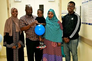 Mr Kase Bonaya holding his three-year-old son Mahadal Kase