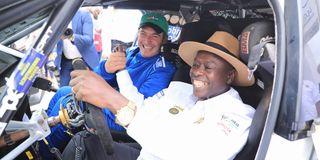 Deputy President Rigathi Gachagua (right) gets a feel of a rally car 