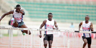 Wiseman Were (left) competes in men's 400m hurdle race