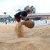 A woman spreads paddy at Mwea Rice Growers Multipurpose Cooperative Society stores in Wang’uru, Kirinyaga County