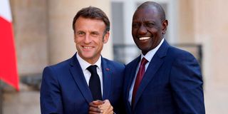 French President Emmanuel Macron (left) shakes hands with Kenyan President William Ruto