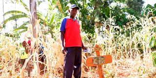 Joel Thuo stands near his son's grave in Murang’a County