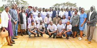 Governor Stephen Sang (in white coat at the centre) with some students and parents at Eliud Kipchoge Stadium in Kapsabet